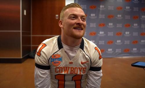 After OSU clinched a berth in the Big 12 title game with a 40-34 double-overtime win over BYU on Saturday, Alan Bowman arrived for postgame interviews wearing Zac Robinson's No. 11 jersey from the 2010 Cotton Bowl, played at AT&T Stadium. That's where the Cowboys face Texas at 11 a.m. Saturday in the Big 12 title game. (OSU Athletics)